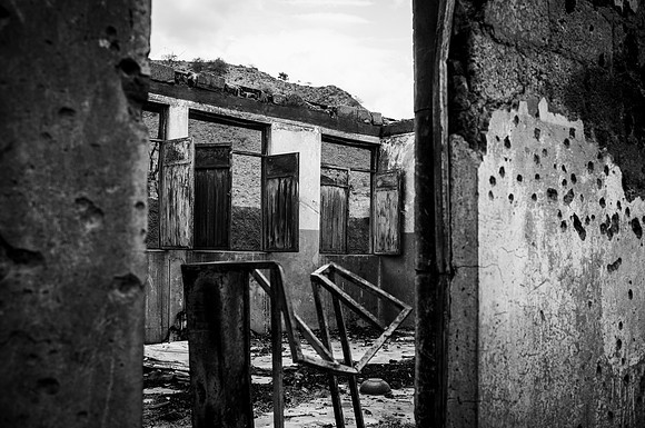 Local school in Erebti covered in bullet holes and cavities caused by rocket attack from the nearby mountains