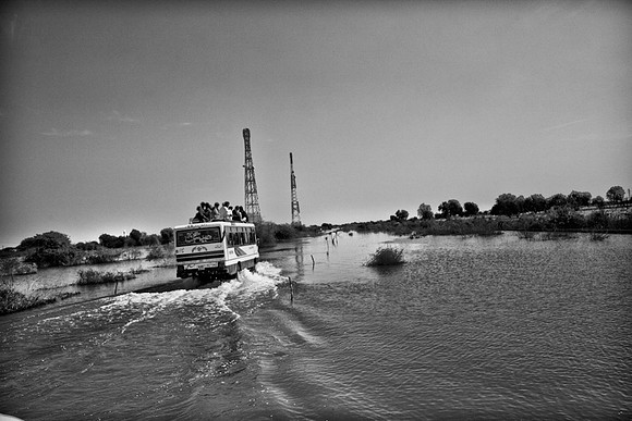 Villagers going about daily lives amidst flood waters