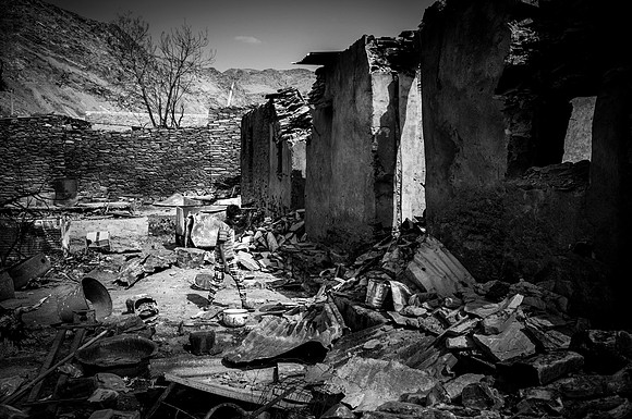 Children rummage through the rubble